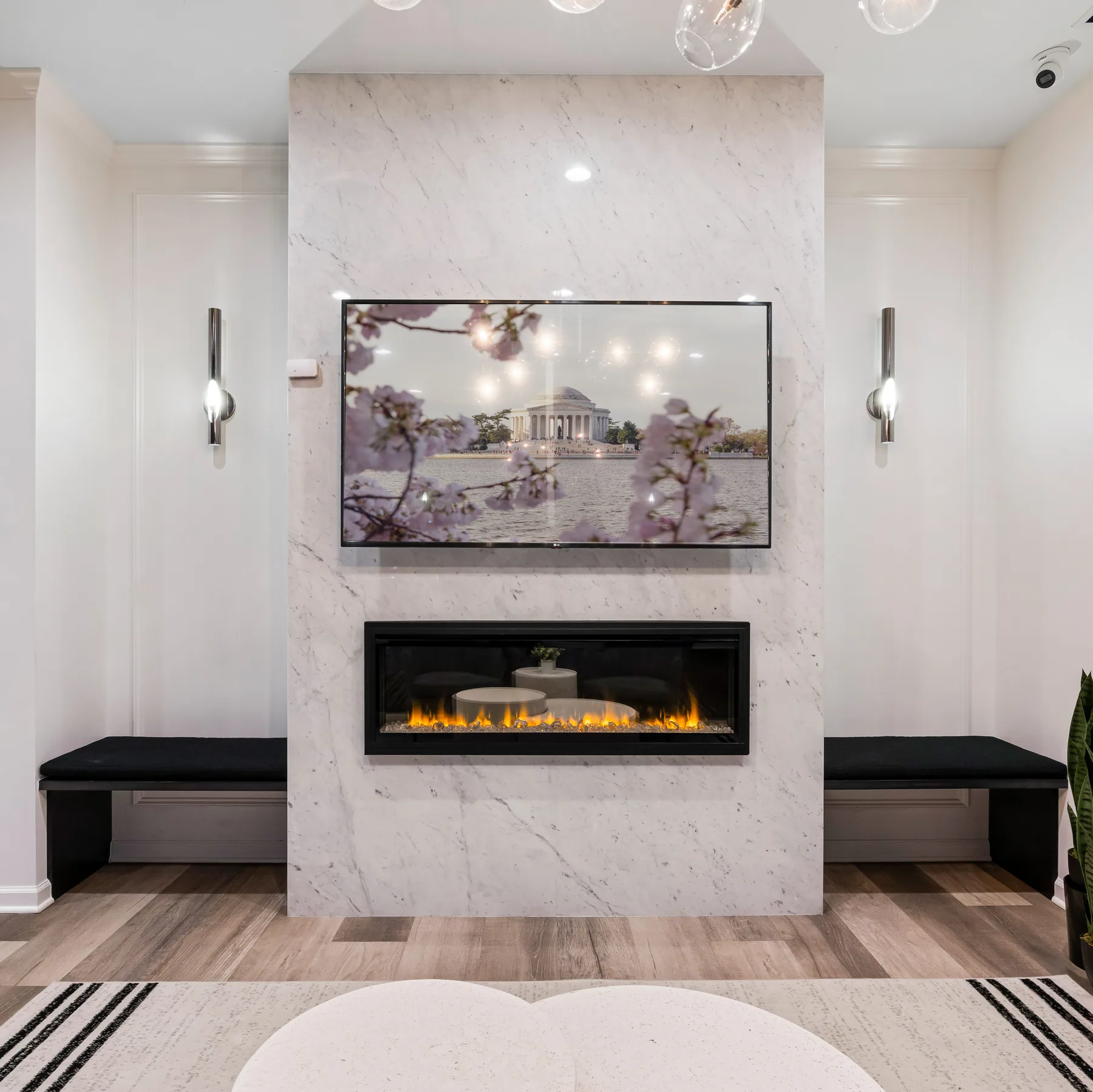 Feature fireplace set in a pale veined wall between low benches.