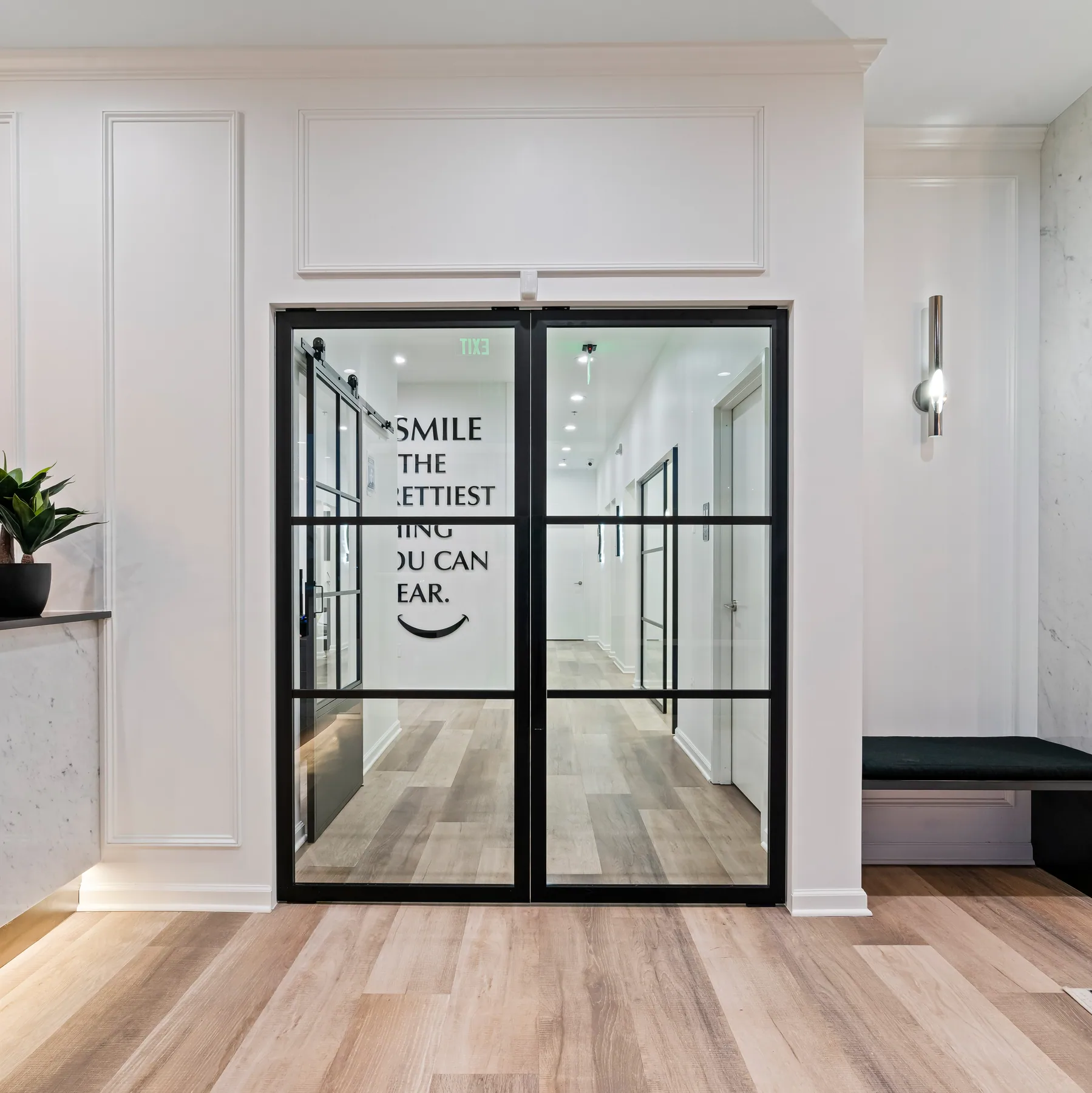 Black-framed glazed doors leading from the waiting room into the clinic.
