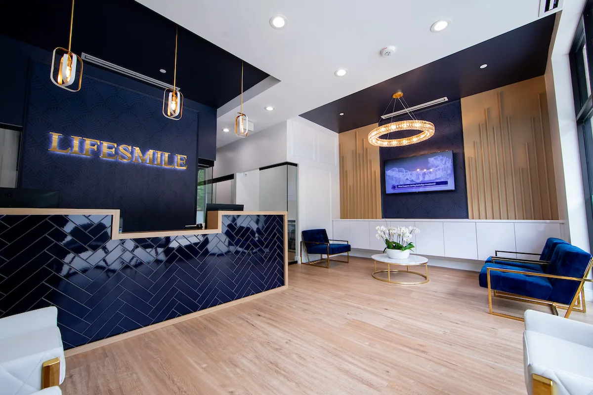 Lifesmile reception with navy walls, timber paneling and blue lounge chairs.
