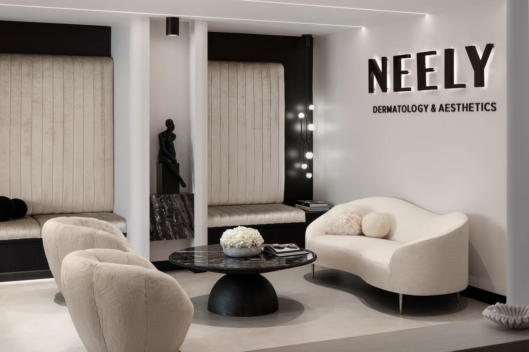 Curved cream seating and sculptural furniture in the Neely waiting lounge.